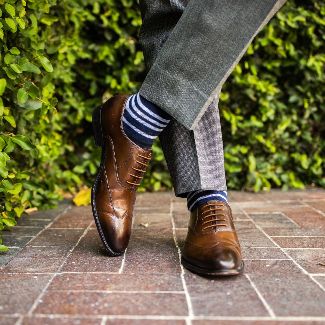 man wearing navy blue sock with white and black stripes