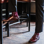 Man wearing Burgundy men's dress socks with white polka dots