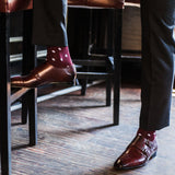 Man wearing Burgundy men's dress socks with white polka dots