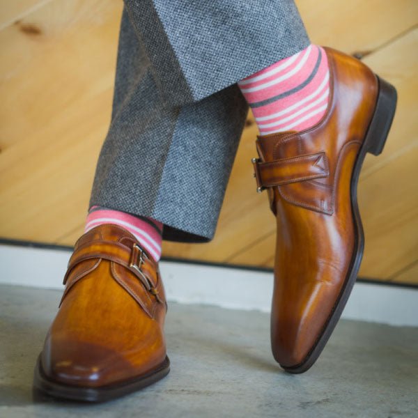Man wearing coral striped socks and grey pants