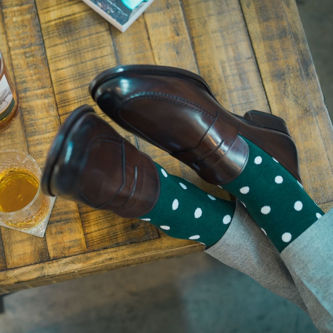 Man wearing green socks with white polka dots