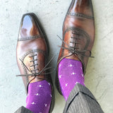Man wearing purple dress socks with white hatches and brown dress shoes