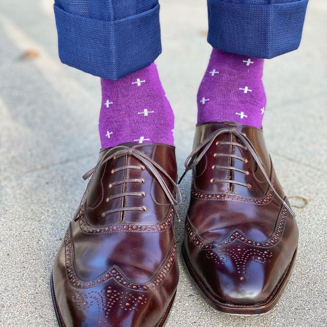 Man wearing purple dress socks with white hatches and brown dress shoes