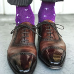 Man wearing purple dress socks with white hatches and brown dress shoes