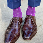 Man wearing purple dress socks with white hatches and brown dress shoes