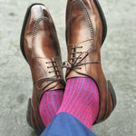 Man wearing blue and red pinstripe dress socks
