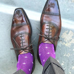 Man wearing purple dress socks with white hatches and brown dress shoes