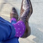 Man wearing purple dress socks with white hatches and brown dress shoes
