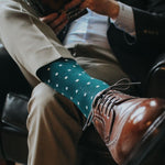Man wearing green socks with white micro-squares and dress shoes