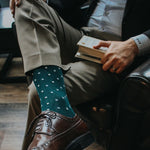 Man wearing green socks with white micro-squares and dress shoes