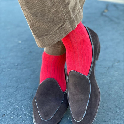 Man wearing rose red ribbed men's dress socks.