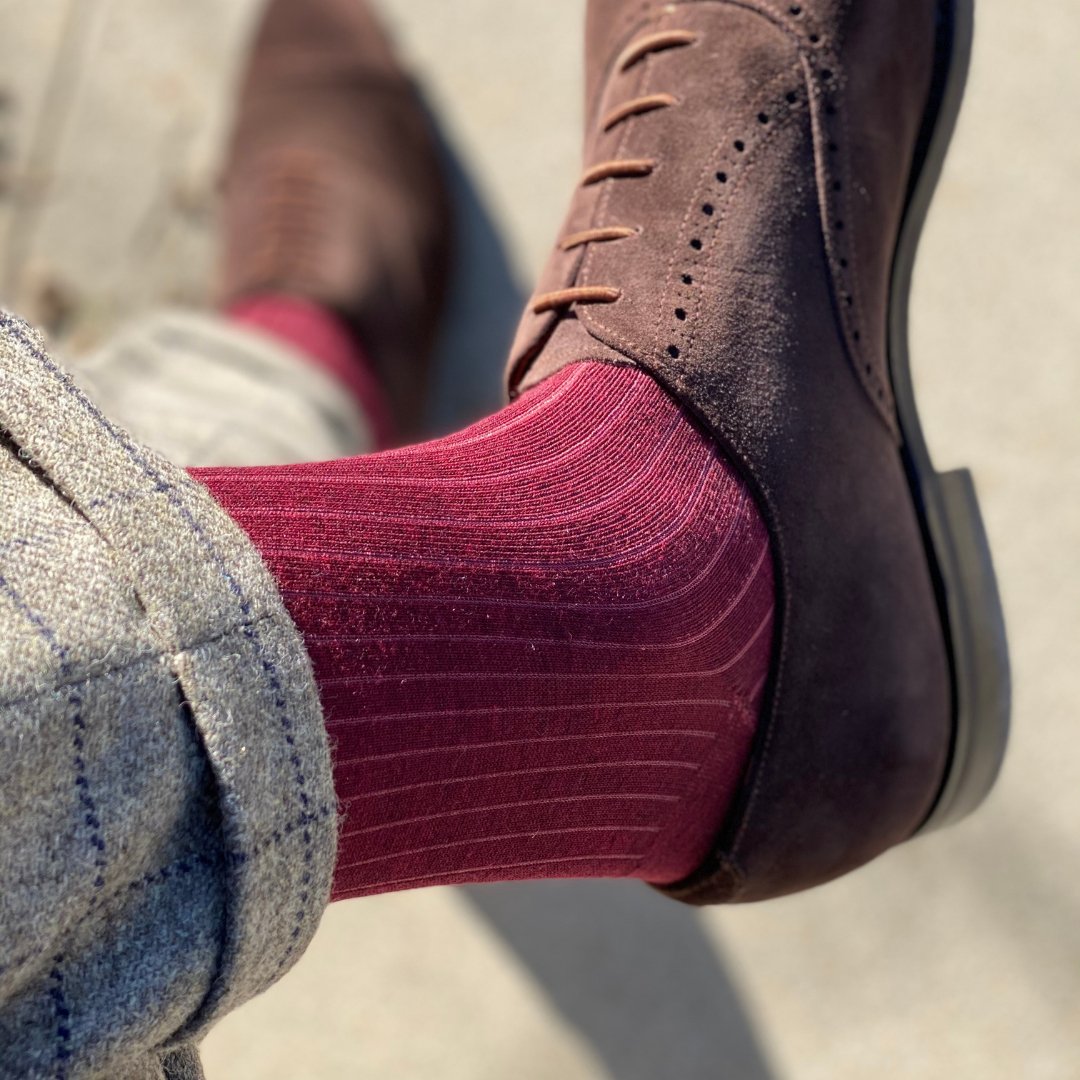 Man wearing solid, merlot ribbed men's socks with dress shoes.