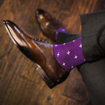 Man wearing purple dress socks with white hatches and brown dress shoes