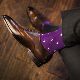 Man wearing purple dress socks with white hatches and brown dress shoes