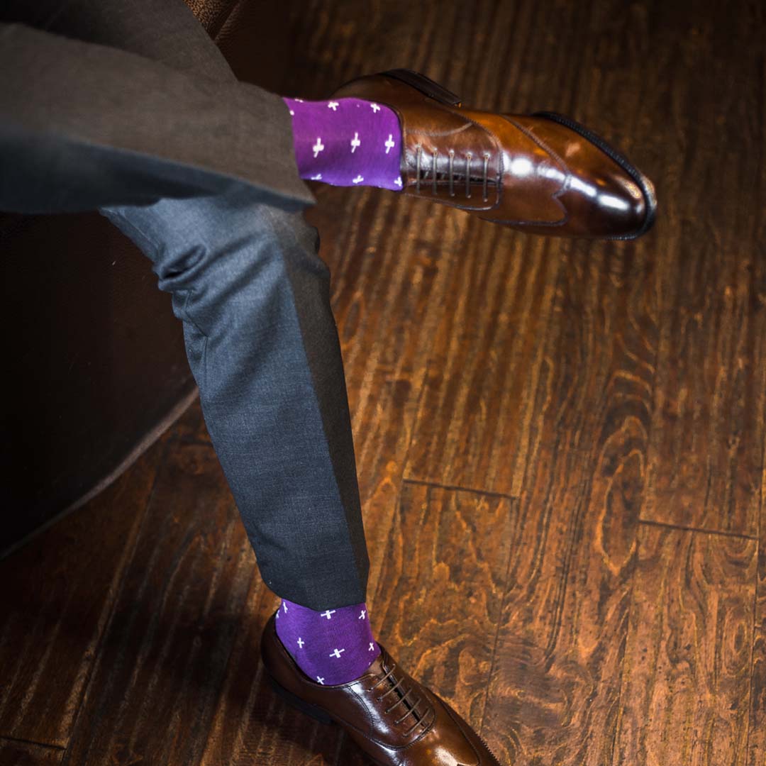 Man wearing purple dress socks with white hatches and brown dress shoes
