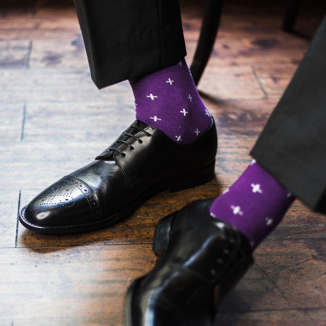 Man wearing purple dress socks with white hatches and dress shoes