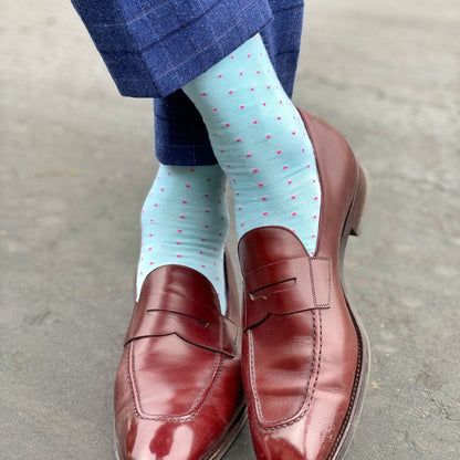 man wearing mint blue socks with pink dots