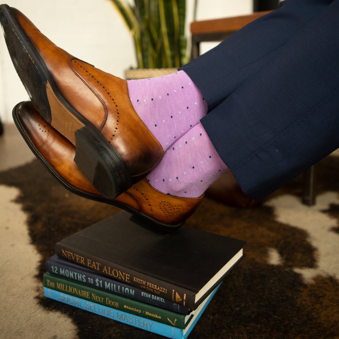 Man wearing a periwinkle purple men's dress sock with navy and baby blue pin dots