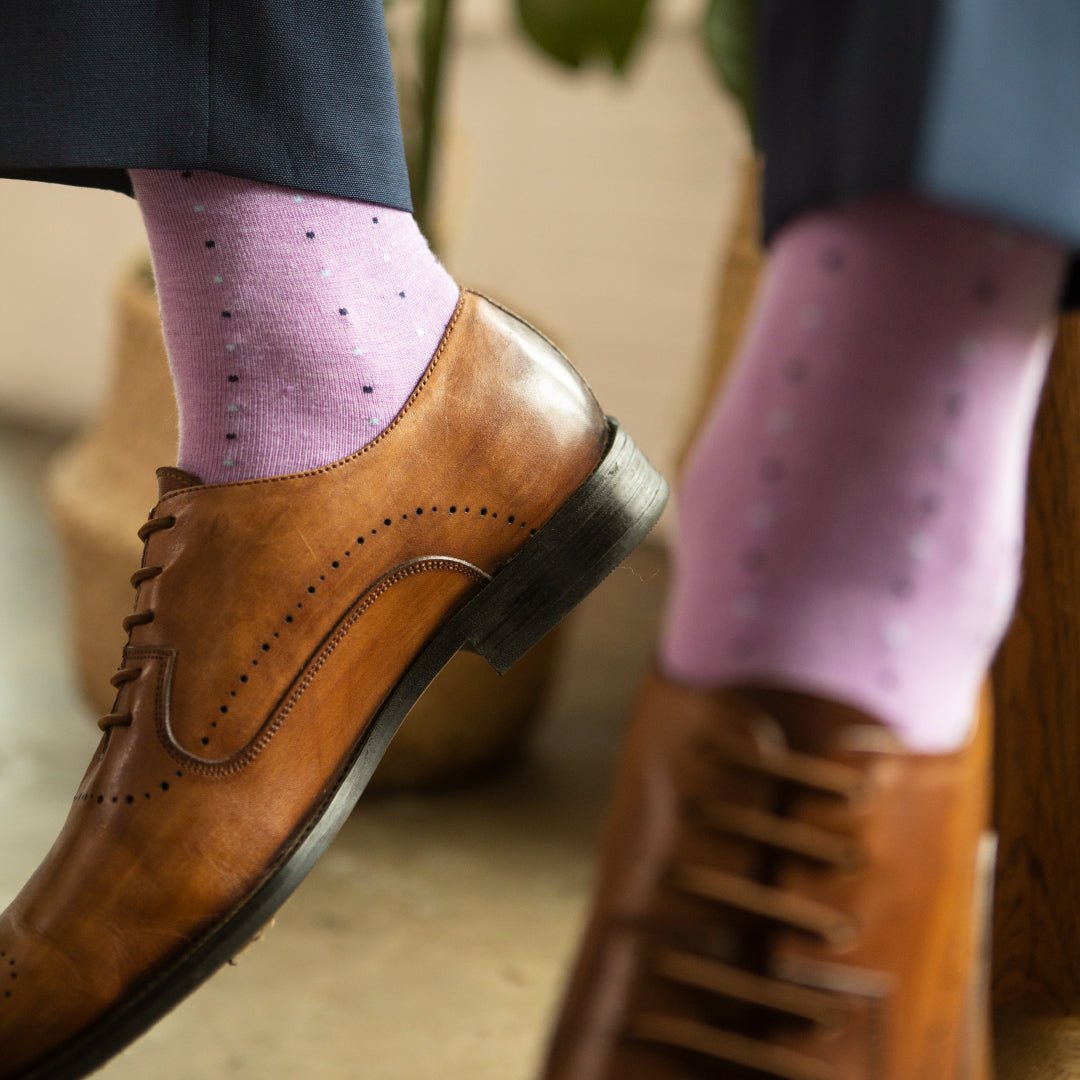 Man wearing a periwinkle men's dress sock with purple, navy and baby blue pin dot pattern