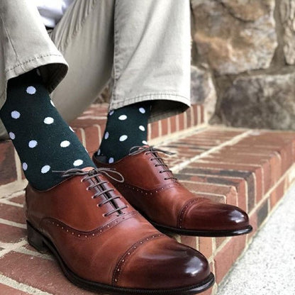 Man wearing green socks and brown shoes