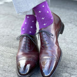 Man wearing purple dress socks with white hatches and brown dress shoes