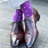 Man wearing purple dress socks with white hatches and brown dress shoes