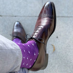 Man wearing purple dress socks with white hatches and brown dress shoes