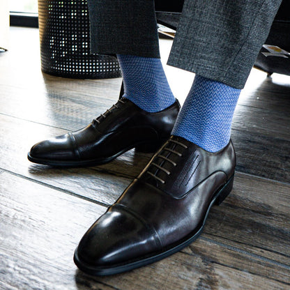 Man wearing Sky blue micro-chevron men's dress socks with grey slacks