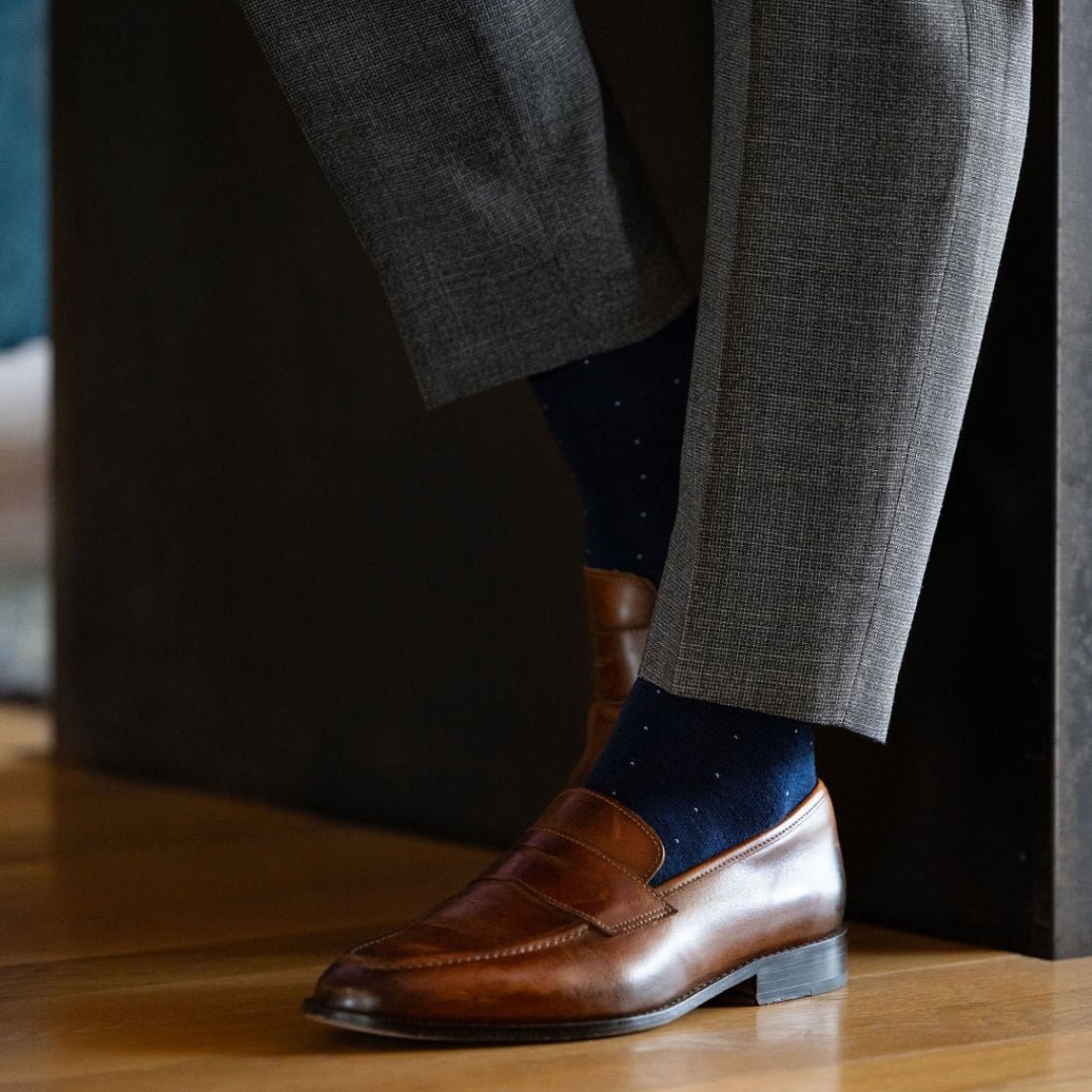 Man wearing blue socks with grey pants