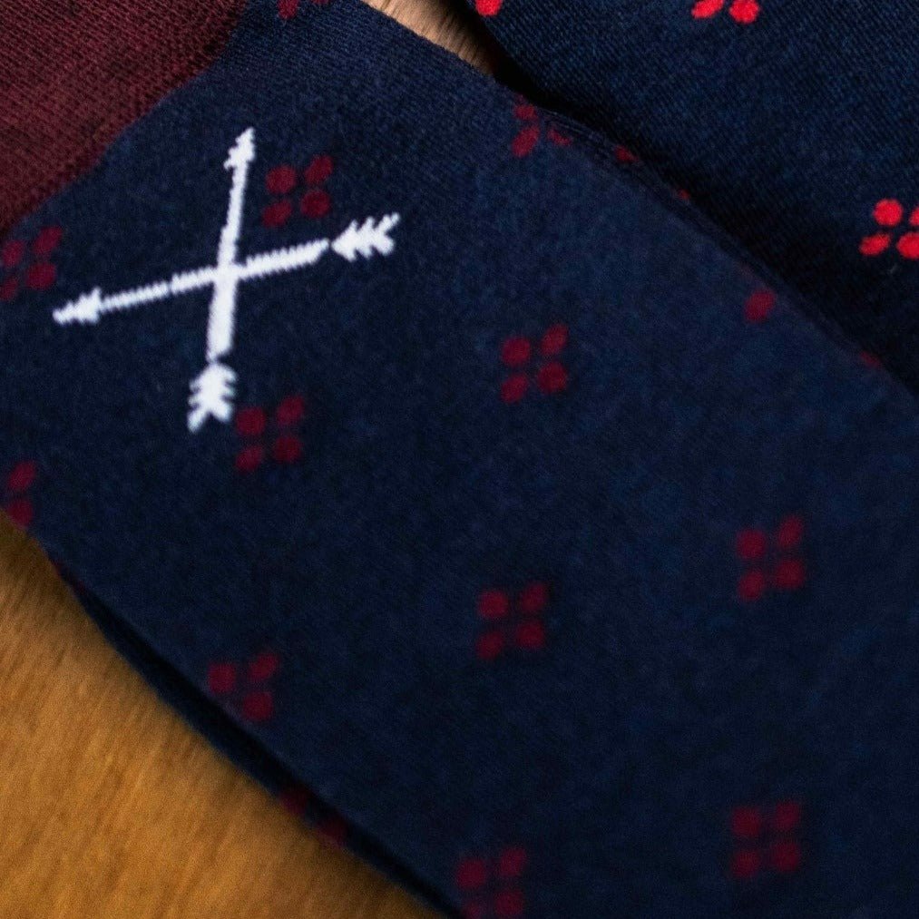 Navy blue men's sock with a garnet red flower pattern