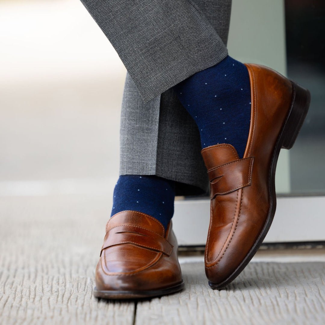 Man wearing blue socks with grey pants