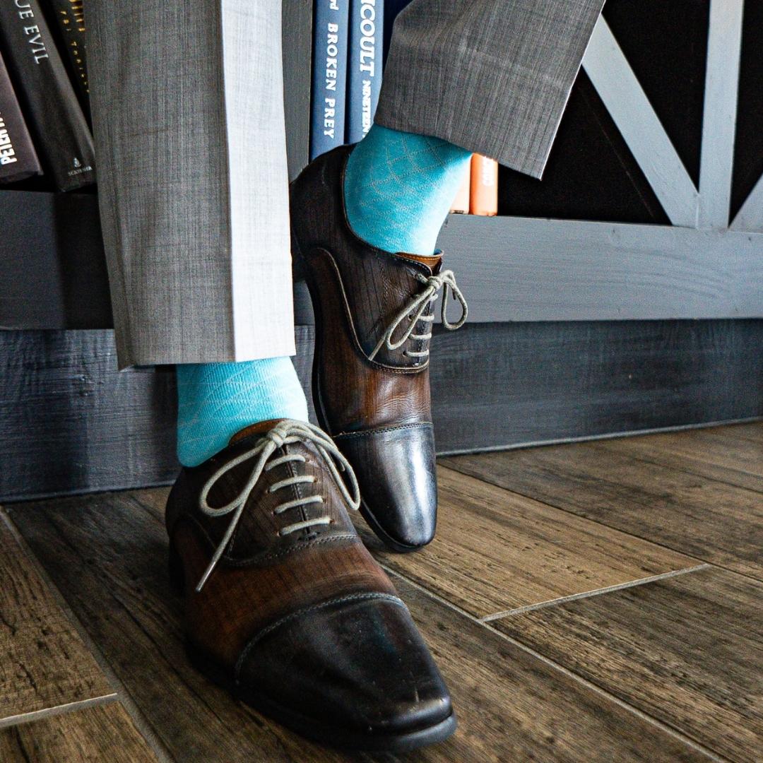 Turquoise blue men's dress sock with white contrasting diamond pattern