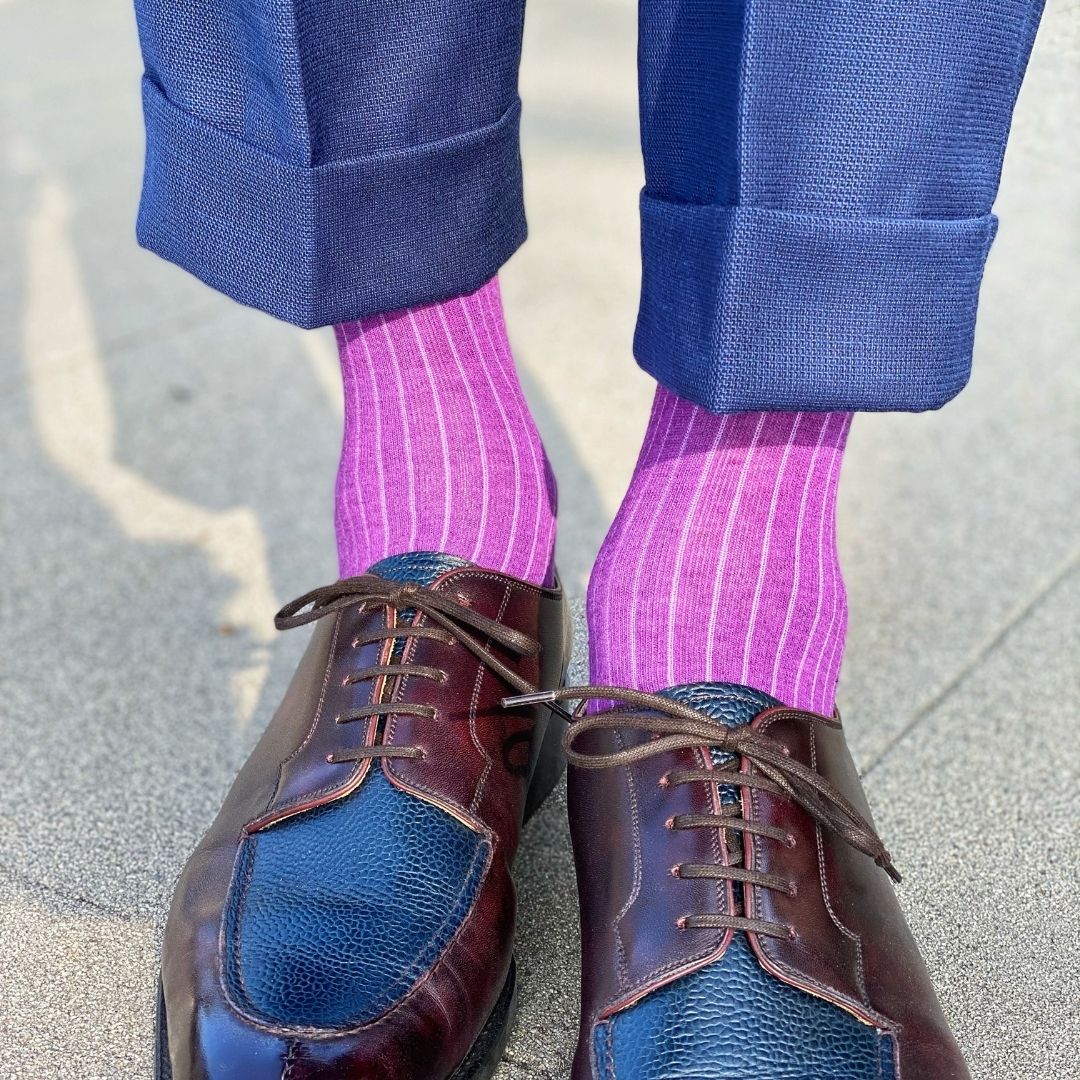 Man wearing fuchsia, solid, ribbed men's dress socks with brown shoes