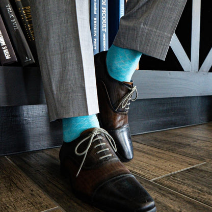Turquoise blue men's dress sock with white contrasting diamond pattern