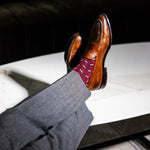 deep red men's dress sock with red and white x pattern