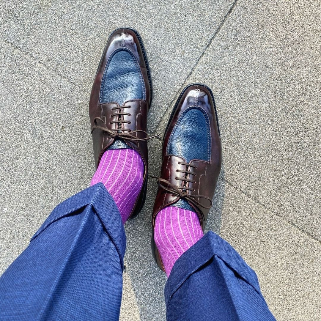 Man wearing fuchsia, solid, ribbed men's dress socks with brown shoes.