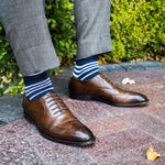 man wearing dark blue sock with white and black stripe pattern