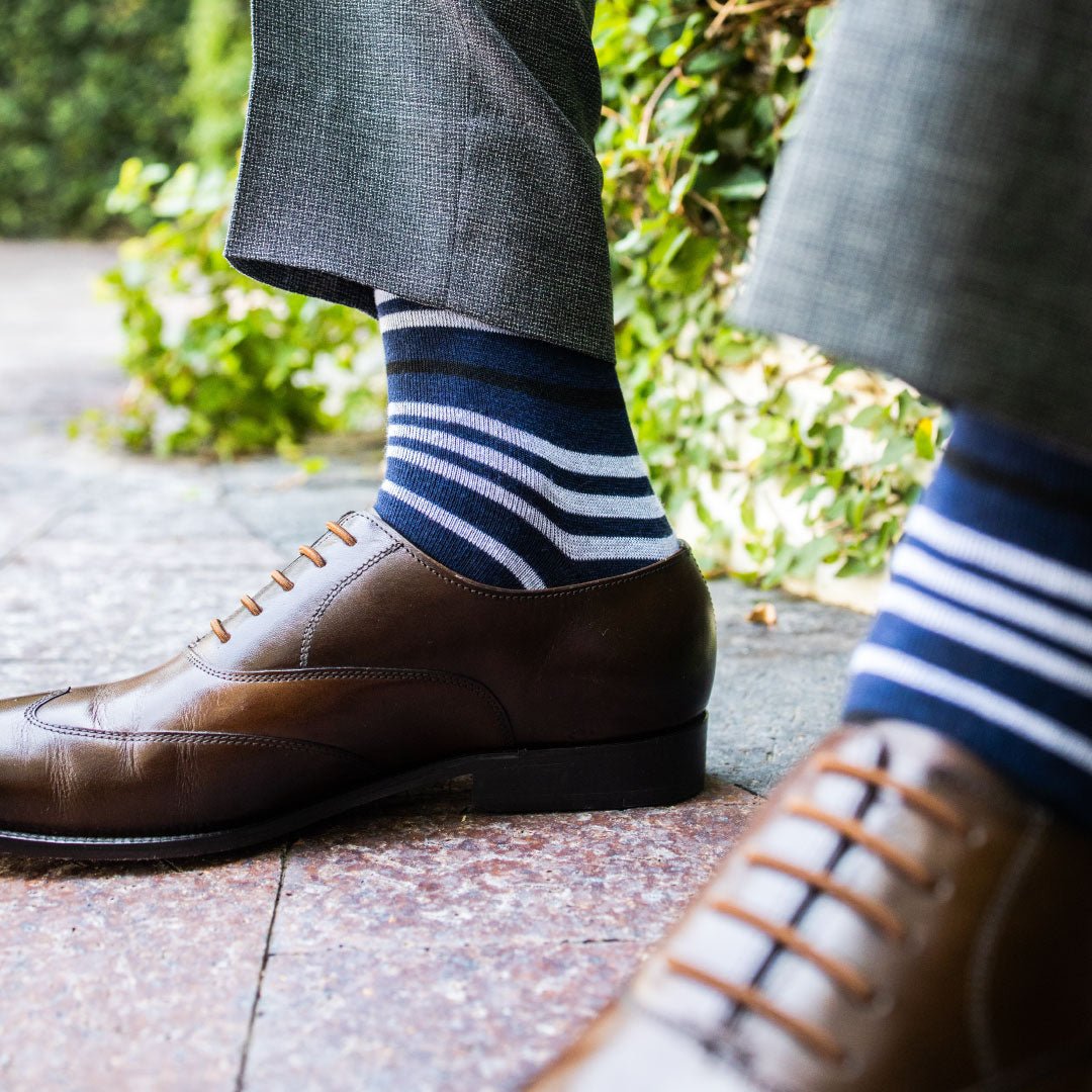 man wearing dark blue sock with white and black stripes