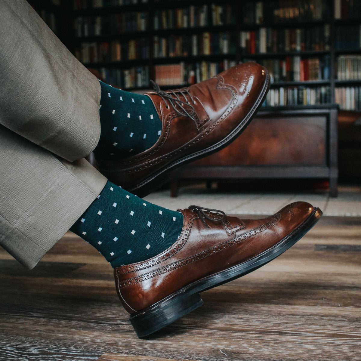 guy wearing sand colored slacks, green socks, with brown dress shoes