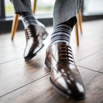 a man wearing grey, blue, and white striped men's dress sock