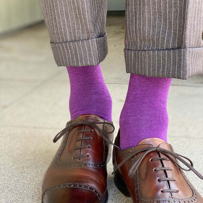 Man standing wearing plum purple men's dress socks and shoes.