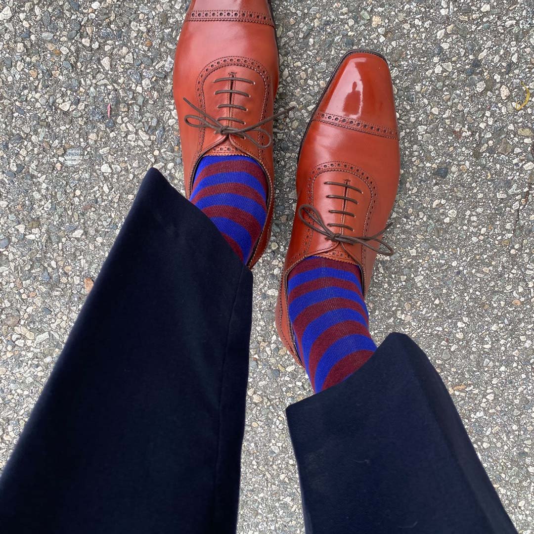 Man standing wearing Red and Blue Rugby Stripe men's dress socks