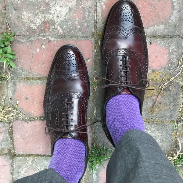 man wearing purple socks