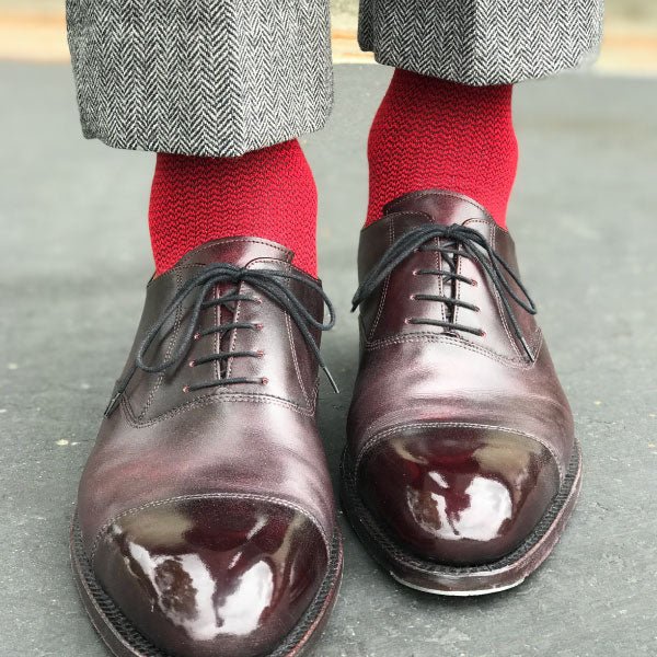 Guy wearing red socks and grey pants
